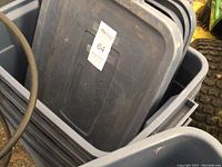 Photo showing a stack of five blue Rubbermaid storage totes and lids, displaying their size, color, and condition.