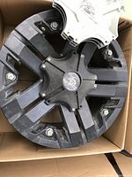 Single Granite alloy rim in cardboard box showing black finish and installed TPMS sensor.