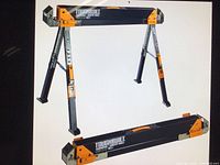 Assembled sawhorse with legs extended in A-frame, showing black steel beam, orange end plates and branding.