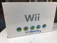 Photo of Wii Sports original packaging box showing white box with Wii Sports images and branding.