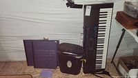 Full lot showing Casio keyboard, paper shredder, and three purple binders of US quarters maps.