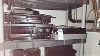 Wide shot of Crosley turntable on bottom shelf, Sony GA7ES stereo receiver, Sony High Density Linear Converter, and black Sony streaming device on shelf