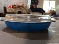 Side view of blue vintage Pyrex oval casserole dish