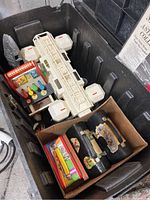 Overview photo of the trunk interior showing vintage Star Wars spacecraft toy, toy cash register, and boxed toy cars.