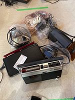 Sony tape recorder TC-120 and assorted cables, headphones, and antennas on floor