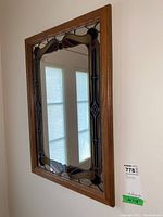 Full view of the mirror showing wood frame and stained glass border.