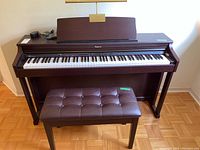 Full front view of Roland digital piano with matching bench