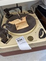Full view of the Garrard cream-colored vintage turntable with rubber platter mat and tonearm on top. Includes a label from the auction house indicating lot 826.