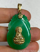 Front view of carved green jade pendant with 18k gold Buddha figure, lotus leaf motif and gold floral bale