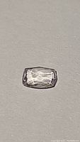 Top-down view of the rectangular cushion-cut pink kunzite gemstone showing facets and clarity.