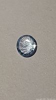 Close-up photo of oval concave cut natural blue topaz gemstone with sky blue color reflecting light.