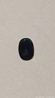 Top view of the oval cut indicolite blue tourmaline stone showing deep blue coloration under normal light.