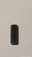 Single bi-coloured tourmaline stone with a black/dark appearance under certain angle.