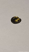 Close up of the oval cut bi-coloured quartz stone showing lemon and smokey quartz colors.