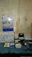 Wide view of all bedding items, showing mattress pad packaging, flannel sheet set, other sheets and pillowcases.