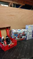 Photo of the three boxed skate items arranged side by side showing CCM skates, Marvel adjustable roller skates box, and white figure skates box.