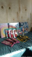 Overview of binders, mathematical instrument sets, pen sets and glue sticks arranged on a table
