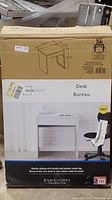 Photo of Original sealed box showing the desk model, dimensions and brand Mainstays.