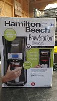 Front view of Hamilton Beach Brew Station coffee maker box, showing product image and features including 12 cup capacity and programmable brewing.