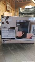 Front view of boxed Keurig K-Slim coffee maker showing product image and brand