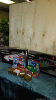 View of boxed foosball table and hover hockey game with Ryan's World toys and Harry Potter wax seals.
