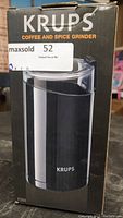 Photo of the KRUPS coffee and spice grinder box, showing the product image and branding.