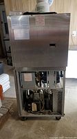 Front and lower section with panel removed showing internal compressor and refrigeration components