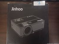 Jinhoo projector black box with white line drawing of the projector on the front, showing brand name and model image