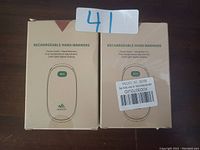 Two boxed rechargeable hand warmers with product labels showing functions and temperature.