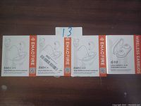 Five unopened boxes of Enacfire wireless earbuds, including four E60 True Wireless Sport Earbuds and one G10 Wireless Earbuds box showing product packaging and branding.