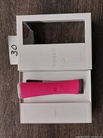 Foreo Espada blue light acne treatment device in box showing device, inner and outer packaging.