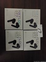 Four retail boxes of Haylou GT7 wireless earbuds arranged in a 2x2 grid showing the front packaging design.