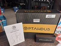 Box, manual, and original packaging for Ptahdus heated jacket with product branding visible.