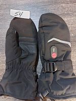 Pair of black heated mitts showing front palm side and back with controls and strap