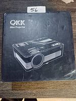 Box of QKK Mini Projector showing brand and model outline image