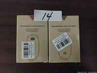 Photo of box packaging showing two boxes of rechargeable hand warmers with labels and lot number 14.