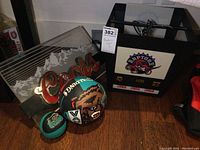 Photo showing Toronto Raptors ceiling light, Coors beer sign, and two basketballs on floor