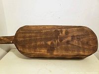 Top view of the rectangular carved wooden bowl showing wood grain and smooth finish.