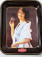 Front of metal serving tray with vintage Coca-Cola advertisement image