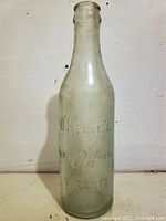 Full front image of the frosted glass bottle with embossed O'Keefe's and Toronto marking on the front, showing overall shape and details.