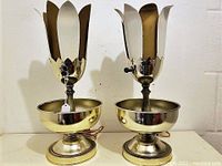 Pair of metallic tulip-shaped lamps with petal-edged shades and round bases; vintage 1970s style.