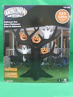 Front view of the boxed Gemmy Airblown Inflatable Halloween Tree showing the inflatable black tree with orange pumpkins and white ghosts and size indication 8.5 feet tall.