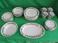 Photo of entire set including 8 dinner plates, 8 salad plates, 8 soup bowls, 8 cups and saucers, serving platter, and serving bowl.