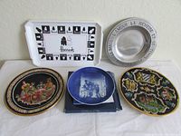 Full view of all six items including Royal Copenhagen plate in box, West Germany plate, Wilton pewter plate, Harrods tray, and two decorative plates
