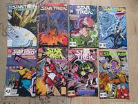 Full view of all 8 Star Trek comic books showing cover art and arrangement