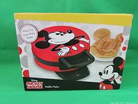 Front view of box showing Disney Mickey Mouse Waffle Maker with image of waffle shaped like Mickey Mouse