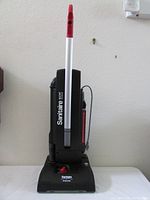 Front view of the upright black vacuum labeled 'Sanitaire quiet' and 'Electrolux' with white handle and red accents.
