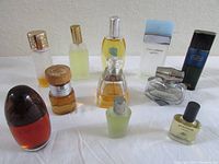 Full view of all perfume and cologne bottles arranged together on tabletop.