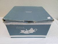 Closed blue box labeled Marquis Waterford Vintage Garden Collection with image of tea set on side.