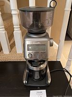 Front view of Breville Smart Coffee Grinder showing bean hopper, digital display, control buttons, and lower grounds collection area.